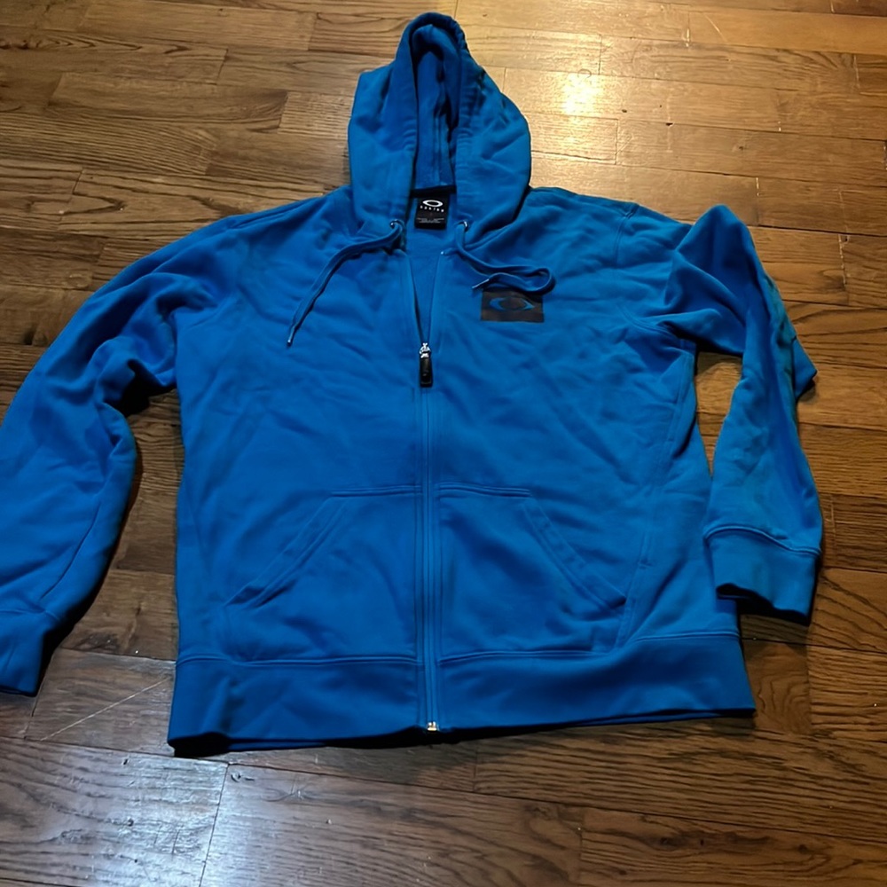 Turquoise Oakley Womens zip up hooded jacket with sleeve print size medium